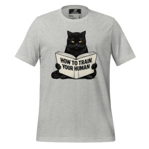 Light gray t-shirt featuring a black cat holding a book with the text "HOW TO TRAIN YOUR HUMAN" in large capital letters.
